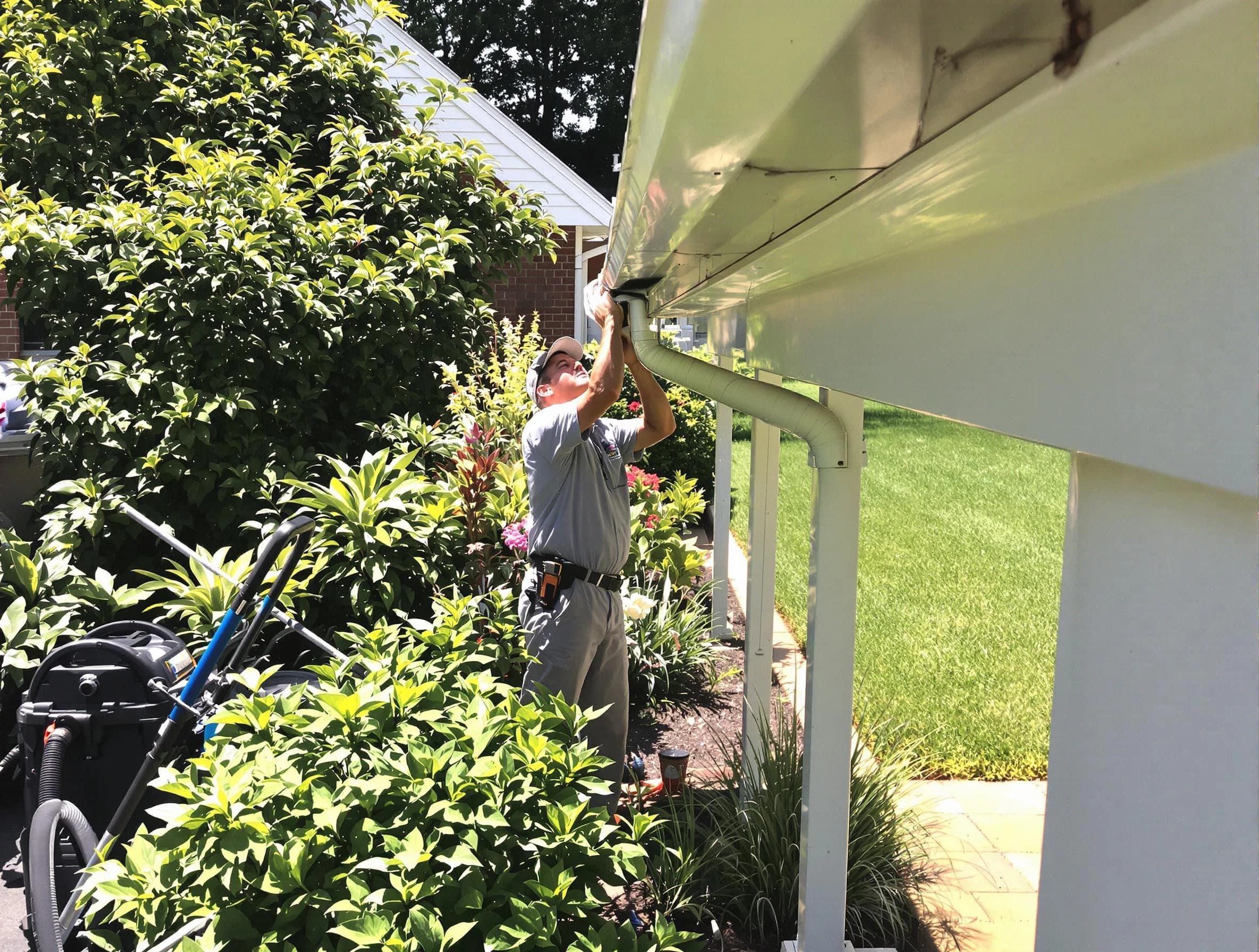 Technician flushing a blockage from a downspout in Willoughby, OH